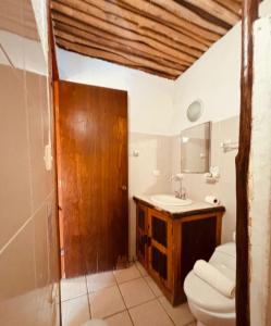 a bathroom with a toilet and a sink at Mayan Mittoz in Holbox Island