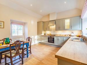 a kitchen with a table and a dining room at 2 bed property in Kelso 86452 in Birgham