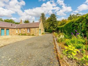 an old stone house with a garden in front of it at 2 bed property in Kelso 86452 in Birgham