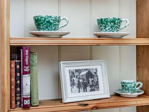 a shelf with two cups and a picture on it at 1 Bed in Poynings 90450 in Poynings