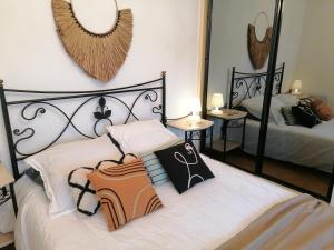 a bedroom with two beds and mirrors on the wall at "Le palmier doré", cosy T3 front de mer in Sanary-sur-Mer