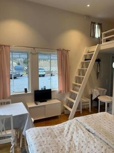 a bedroom with a bunk bed and a staircase at Kojan in Vaxholm