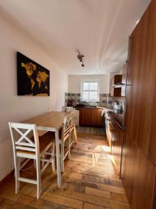 a kitchen with a table and chairs and a refrigerator at City centre apartment next to Bus and Train Station in Inverness