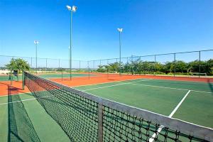 una pista de tenis con red en una pista de tenis en Jackal Creek Golf Estate en Roodepoort