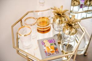 a glass table with glasses and a book on it at The Nici in Bournemouth