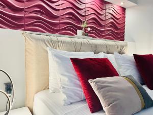 a bedroom with a bed with red and white pillows at eliTe deluxe 2 in Kavala