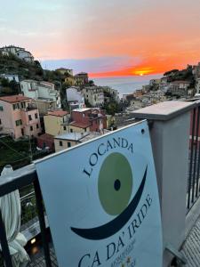 a view of a city at sunset from the balcony of a building at Locanda Ca Da Iride in Riomaggiore