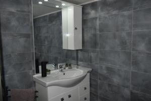 a bathroom with a sink and a mirror at Alios apartment in Rhodes Town +26 photos