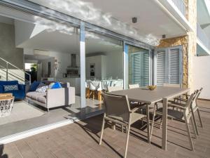 a dining room and living room with a table and chairs at Luxury House - Privat Heated Pool & Ecologic & BBQ & Privacy & Albufeira in Albufeira