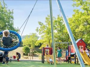 a group of children playing on a playground at Maison cosy 4-6 personnes - Village Pierre & Vacances in Grospierres