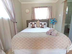 a bedroom with a bed with two dogs on it at OR Tambo Stay Unit 3 in Boksburg