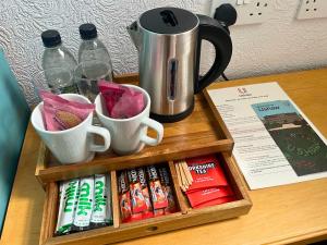 a tray with cups and books on a table at Ushaw Historic House, Chapels & Gardens in Durham