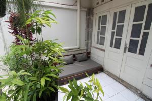 a porch with a couch in front of a door at The Patio Yogya in Yogyakarta