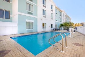 a swimming pool in front of a building at Comfort Suites Fernandina Beach at Amelia Island Soon to be Surf & Sand Ascend Collection by Choice in Fernandina Beach