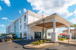 a large white building with a parking lot at Surf and Sand Fernandina Beach at Amelia Island, Ascend Hotel Collection - Formerly Comfort Suites in Fernandina Beach