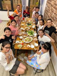 a group of children sitting around a table eating food at Nhà Nhi Đà Lạt in Da Lat