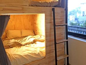 a bedroom with a bunk bed with a ladder at Nhà Nhi Đà Lạt in Da Lat +24 photos