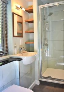 a bathroom with a sink and a shower at North Mundham Cottage, Shared Pool, Tennis Court, Zip Wire & Table Tennis! DOG FRIENDLY in North Mundham