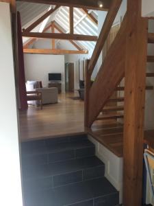 a view of the living room and stairs to the loft at North Mundham Cottage, Shared Pool, Tennis Court, Zip Wire & Table Tennis! DOG FRIENDLY in North Mundham