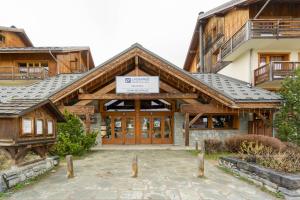 a building with a sign on the front of it at Ecrin des sybelles in La Toussuire