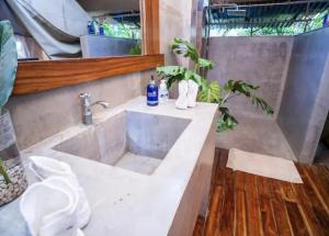 a bathroom with a sink and a mirror at Curiol Boutique Hotel & Lounge in Potrero