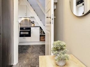 a kitchen with a counter and a table and a mirror at 6 person holiday home in V ggerl se in Marielyst