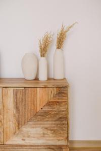 three white vases sitting on top of a wooden shelf at Pure Flor de Esteva in Vila do Bispo