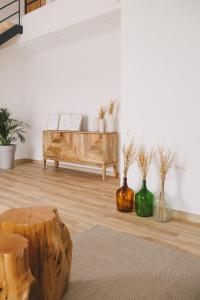 a living room with a bench and vases on the floor at Pure Flor de Esteva in Vila do Bispo