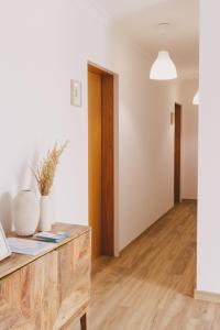 a living room with white walls and wooden floors at Pure Flor de Esteva in Vila do Bispo