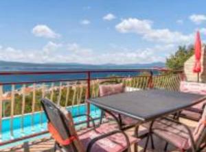 a table and chairs on a balcony overlooking the water at Apartments Panorama in Crikvenica