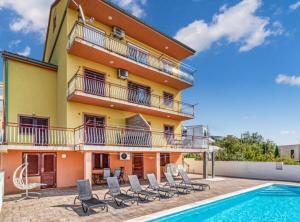 a villa with a swimming pool and a house at Apartments Panorama in Crikvenica