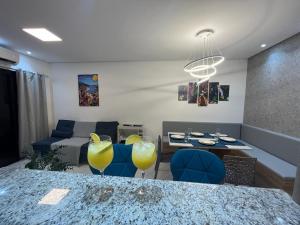 a living room with a table and two yellow glasses at Apartamento Canto Do Forte - Praia Grande Top in Praia Grande