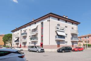 a large white building with cars parked in a parking lot at Sweet Dreams Verona in Verona