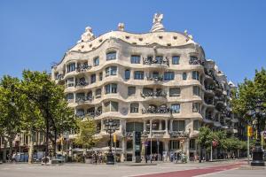 a large building on the corner of a street at Habitat Apartments Pedrera in Barcelona