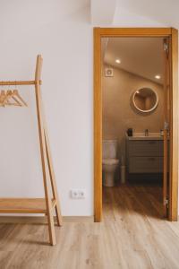 a bathroom with a toilet and a wooden doorway at Pure Flor de Esteva in Vila do Bispo