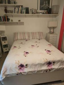 a bedroom with a bed with flowers on it at Dependance in private garden ID29923 in Rome