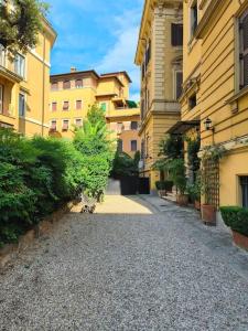 an empty street in front of some buildings at Dependance in private garden ID29923 in Rome