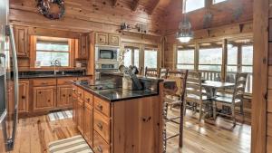 a kitchen with wooden cabinets and a dining room with a table at A Family Affair in Blue Ridge