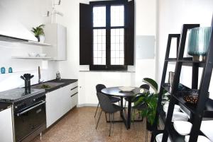 a kitchen with a table and a small table and chairs at Mana Urban Retreat in Ravenna