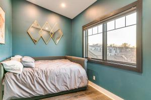 A bed or beds in a room at Stylish Omaha Home with Balcony - 2 Mi to Downtown!
