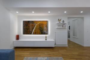 a white living room with a painting on the wall at Magnificent Riviera Residence in Athens