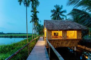 a house on a boardwalk on the water at New Sunshine Homestay in Hoi An