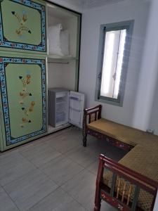 a room with a table and a chair and a mirror at villa izabelles in Djerba