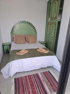 a bedroom with a bed with two hats on it at villa izabelles in Djerba