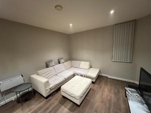 a living room with a white couch and a tv at Beautiful 1-Bed Apartment in Liverpool in Liverpool