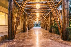 a hallway with bamboo poles in a building at The Victoria Resort Sam Son in Sầm Sơn