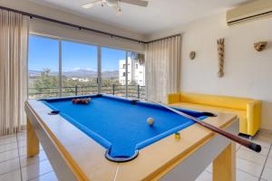a pool table in a living room with a view at Blue Bay #419 in Cabo San Lucas