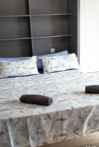 a bed with two pillows on top of it at APART HOTEL in Alicante