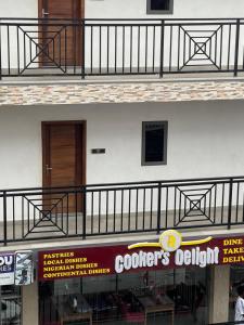 a building with a balcony and a sign for a restaurant at American mall in Accra