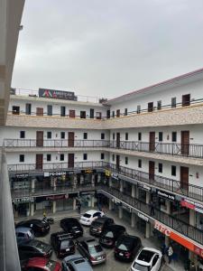 a parking lot in front of a large building at Am apartment in Accra